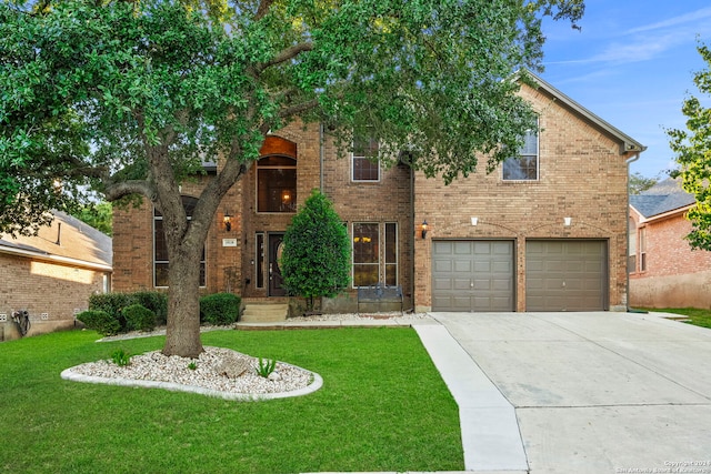 view of front of house with a garage and a front lawn