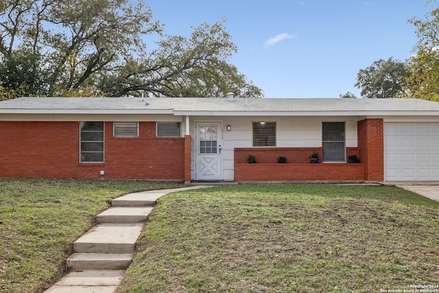 single story home featuring a garage and a front lawn