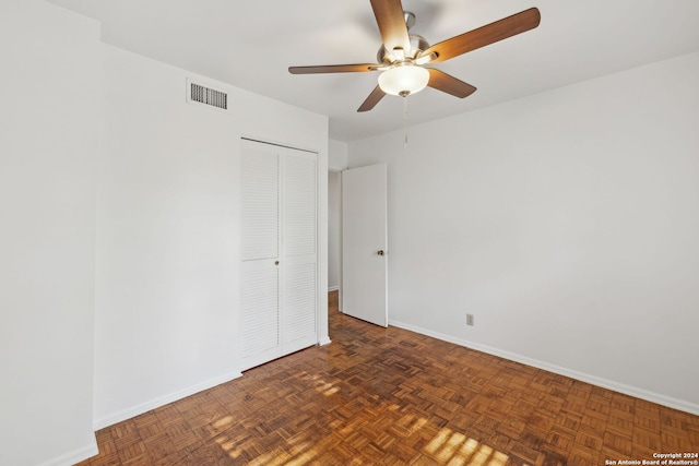 unfurnished room featuring dark parquet flooring and ceiling fan