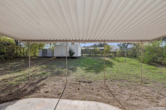 view of yard featuring a patio and a storage unit