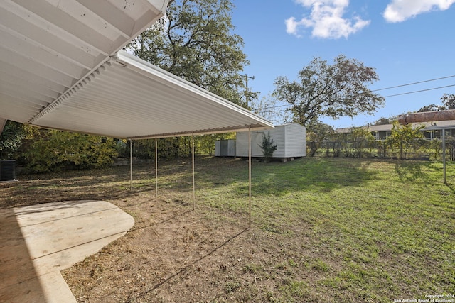 view of yard with a storage shed and a patio area