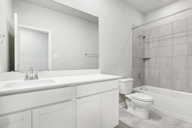 full bathroom with tiled shower / bath combo, vanity, tile patterned floors, and toilet