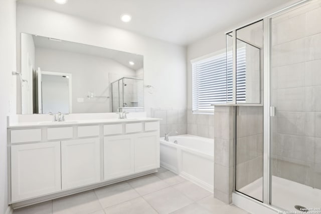 bathroom with independent shower and bath, vanity, and tile patterned floors