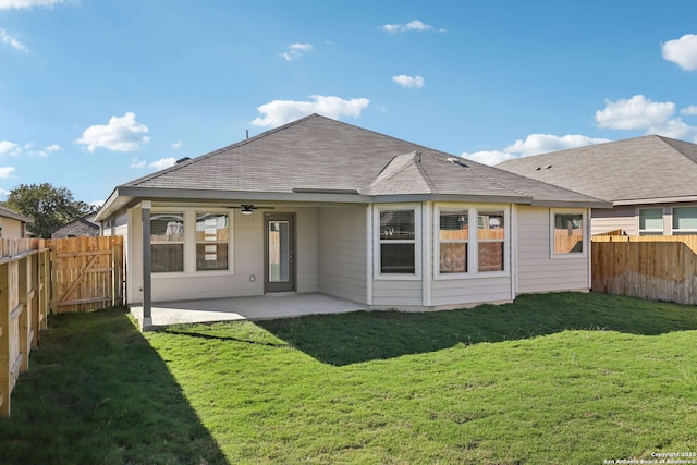 back of property featuring a yard, ceiling fan, and a patio area