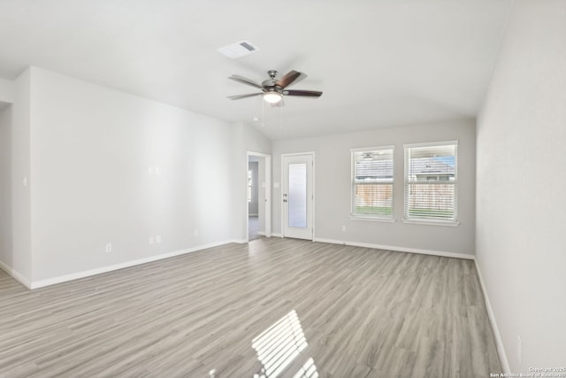 spare room with vaulted ceiling, light hardwood / wood-style floors, and ceiling fan