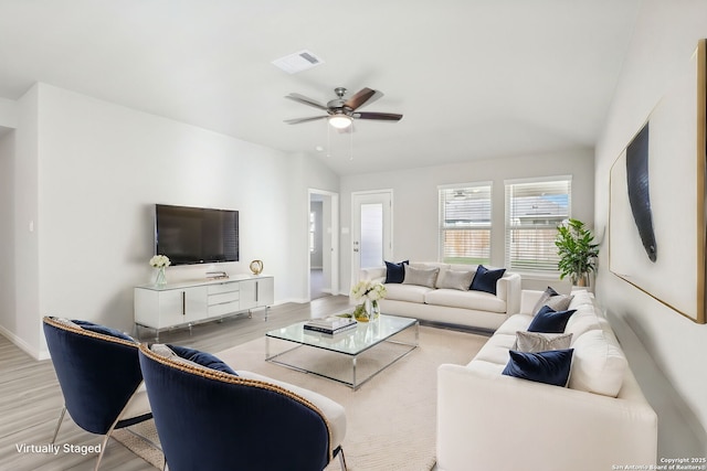 living room with vaulted ceiling, ceiling fan, and light hardwood / wood-style floors