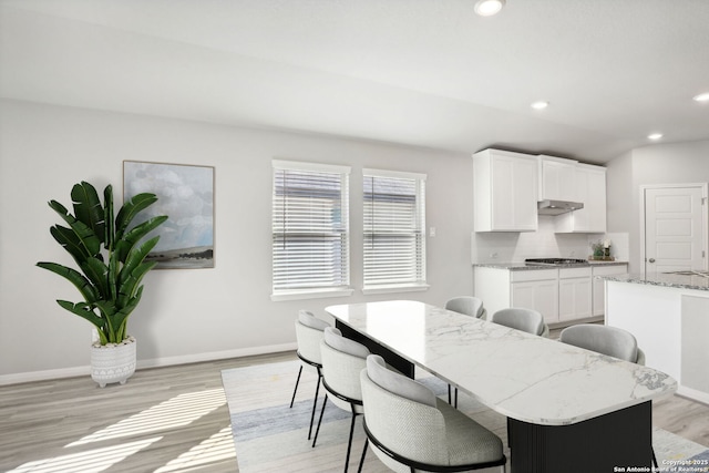 dining space with light hardwood / wood-style floors