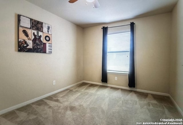 spare room featuring ceiling fan and carpet flooring