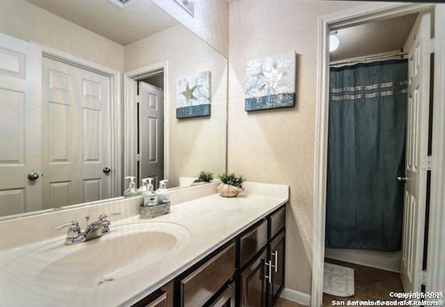 bathroom with tile patterned flooring and vanity