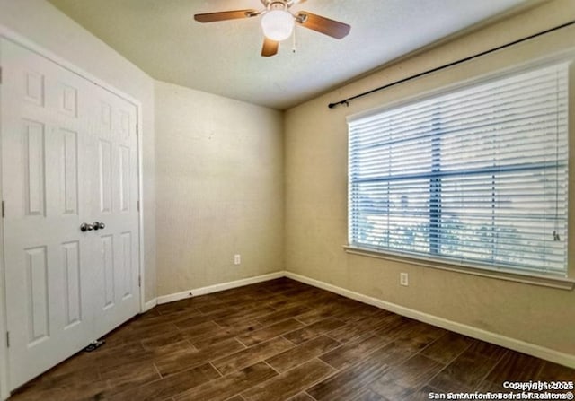 unfurnished bedroom with multiple windows, a closet, and ceiling fan