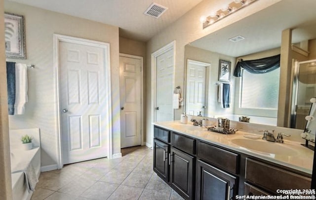 bathroom featuring tile patterned floors, plus walk in shower, and vanity