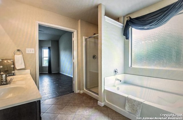 bathroom with vanity, plus walk in shower, and tile patterned flooring