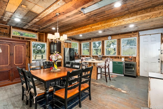 dining area with wine cooler, wood ceiling, a chandelier, and dark wood-type flooring