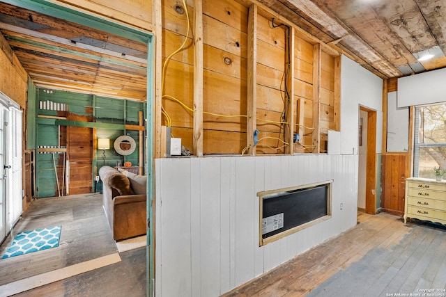 interior space featuring wood-type flooring and wooden walls