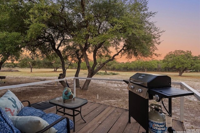 deck at dusk with grilling area