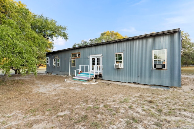 rear view of house featuring french doors