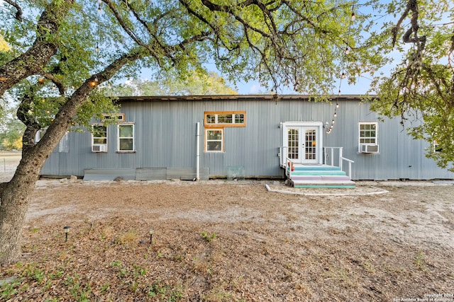 back of property with french doors and cooling unit