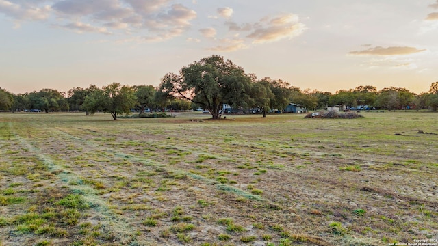 yard at dusk with a rural view