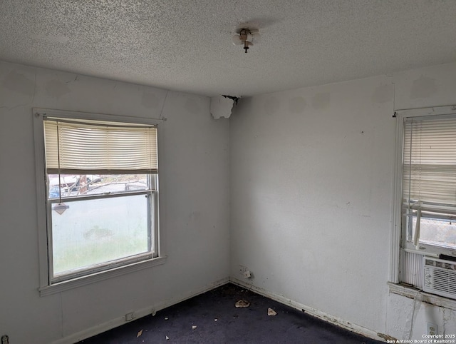 spare room with a textured ceiling