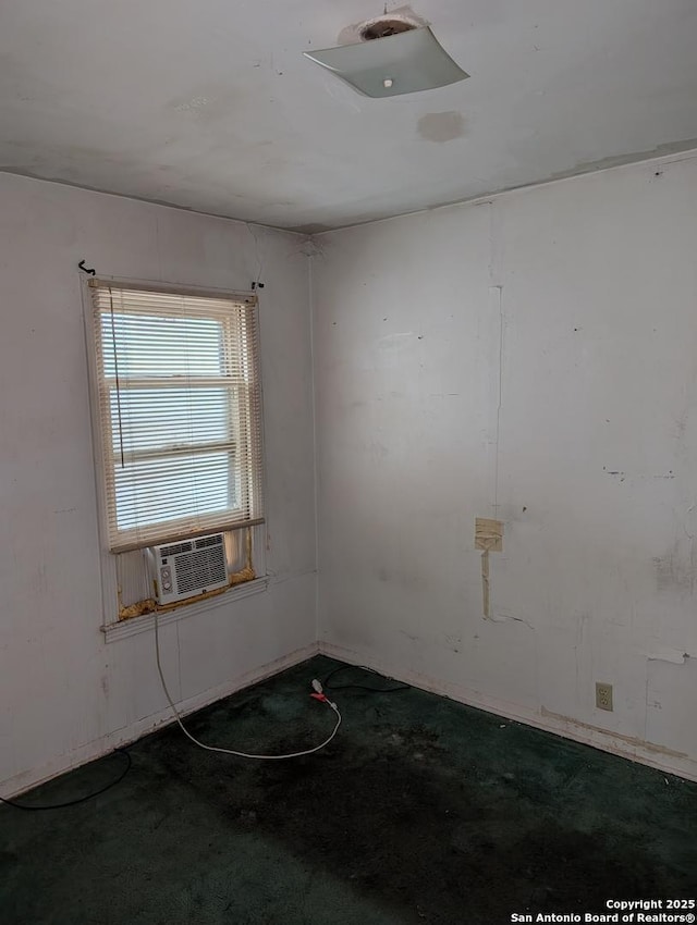 empty room featuring cooling unit and carpet floors