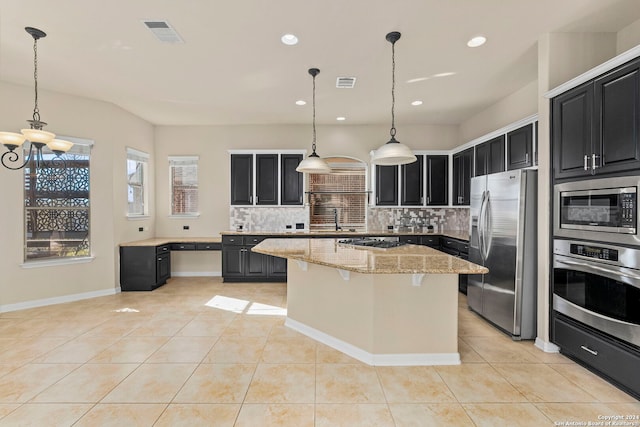 kitchen featuring light stone counters, appliances with stainless steel finishes, a center island, and light tile patterned flooring