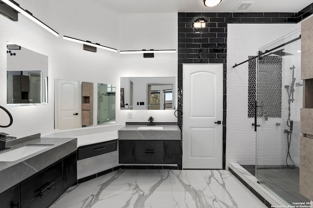 bathroom with vanity and a shower with door