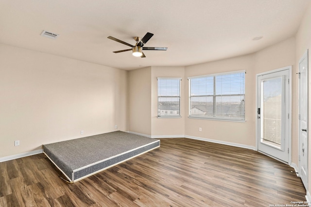 spare room with ceiling fan and dark hardwood / wood-style flooring