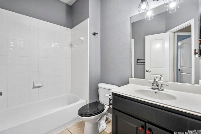 full bathroom with vanity, tile patterned floors, toilet, and washtub / shower combination