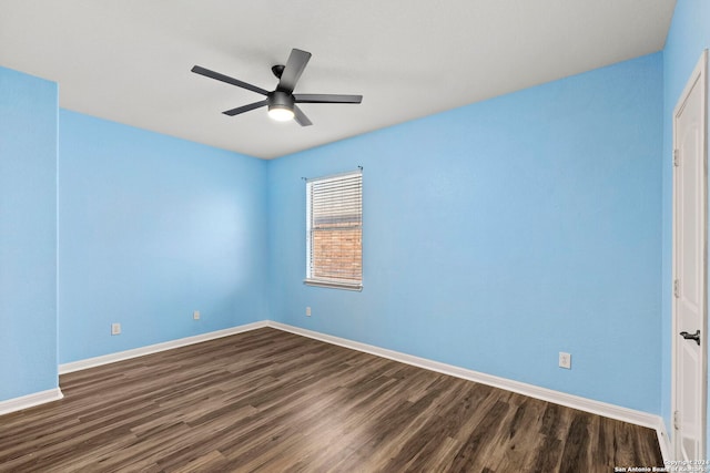 unfurnished room featuring dark wood-type flooring and ceiling fan