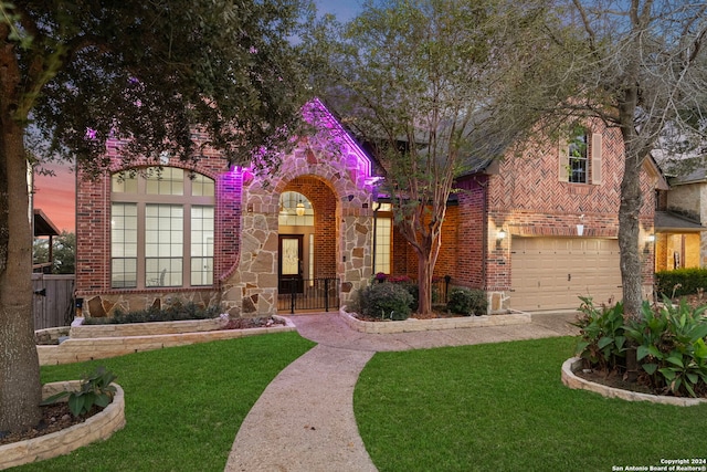 view of front of house featuring a garage and a lawn