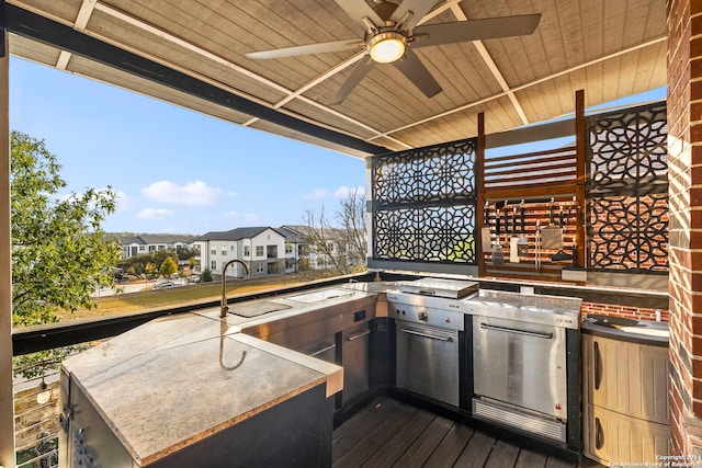 deck featuring ceiling fan, area for grilling, and sink