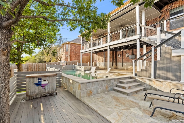 wooden terrace featuring a patio area