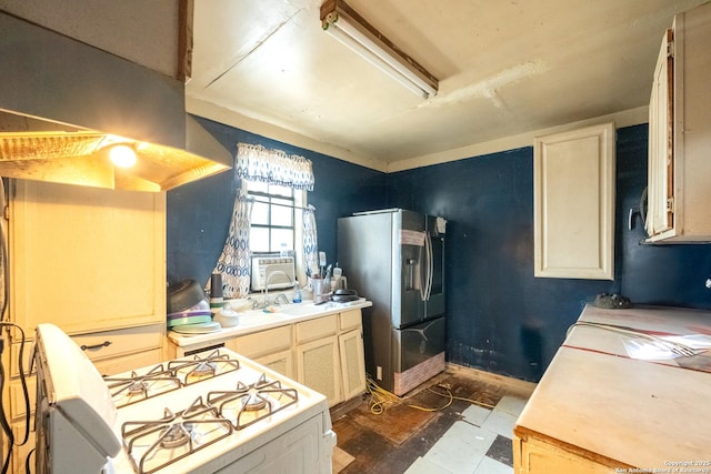 kitchen featuring white range with gas cooktop, cooling unit, sink, and stainless steel refrigerator with ice dispenser