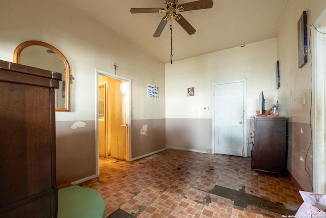 interior space with ceiling fan