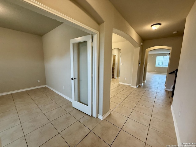 hall with light tile patterned floors