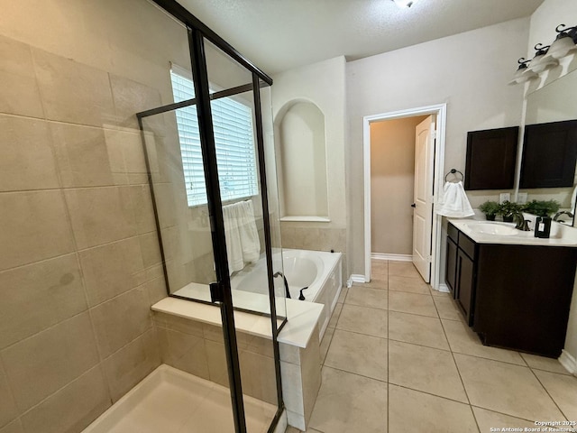 bathroom featuring tile patterned floors, vanity, and independent shower and bath