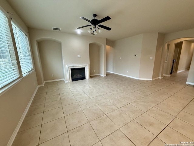 unfurnished living room featuring light tile patterned floors and ceiling fan