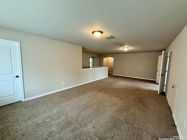 carpeted spare room with a textured ceiling