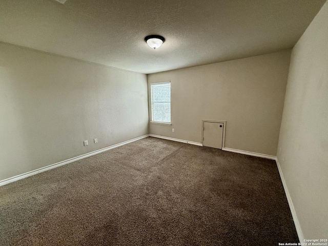 carpeted empty room with a textured ceiling