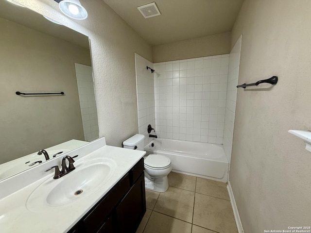 full bathroom with tile patterned flooring, vanity, tiled shower / bath combo, and toilet