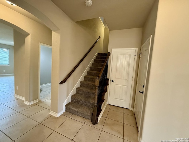 stairs featuring tile patterned floors