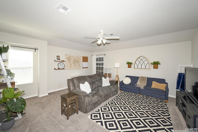 living room with ceiling fan and carpet