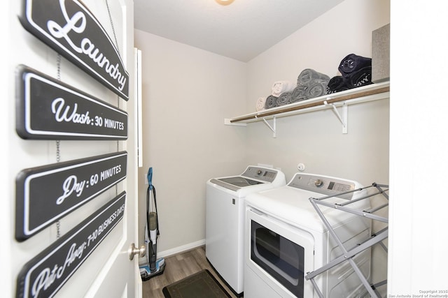 laundry area featuring hardwood / wood-style flooring and washer and clothes dryer