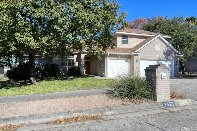 view of front of property with a garage and a front lawn