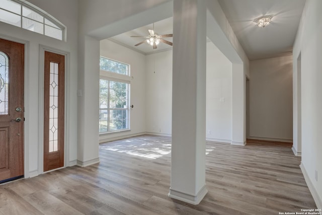 foyer with ornamental molding, ceiling fan, and light hardwood / wood-style floors