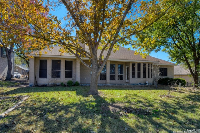 rear view of house with a lawn