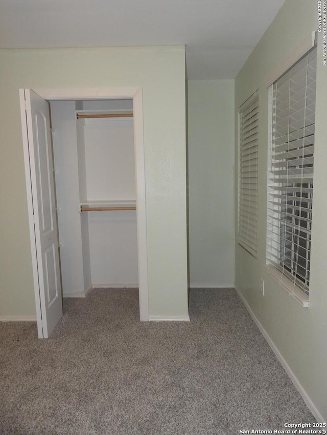 unfurnished bedroom featuring a closet and carpet flooring