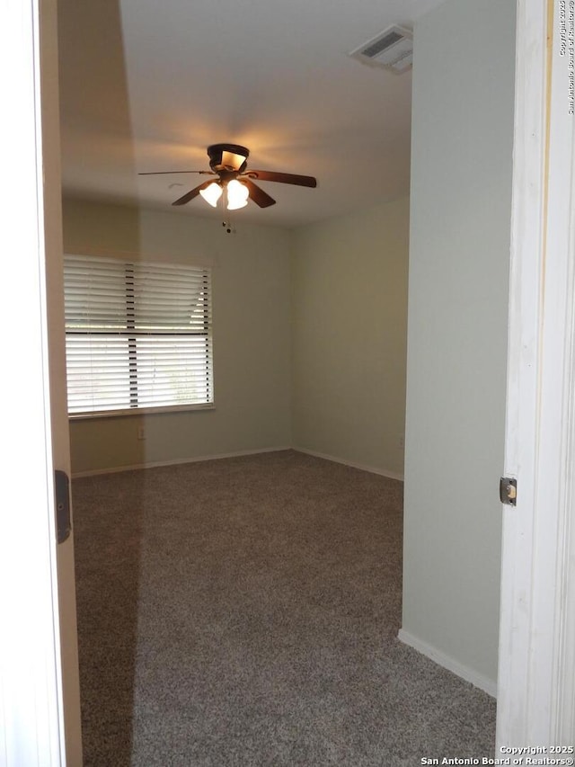 carpeted spare room with ceiling fan