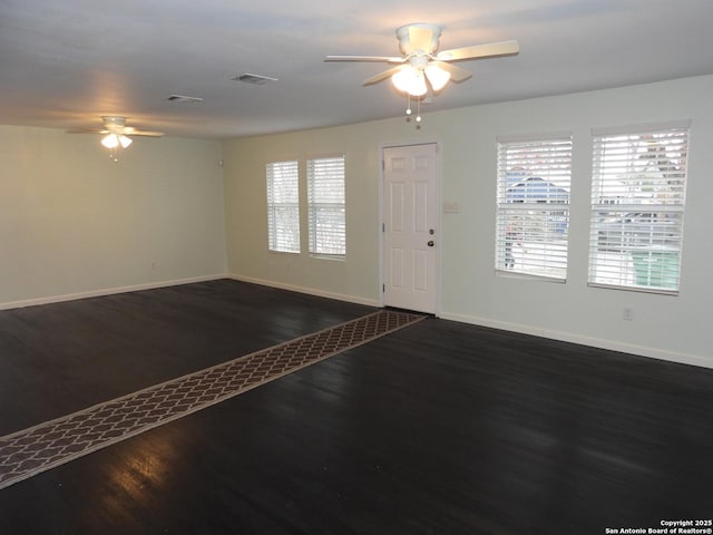 entrance foyer featuring dark wood-type flooring, ceiling fan, and plenty of natural light