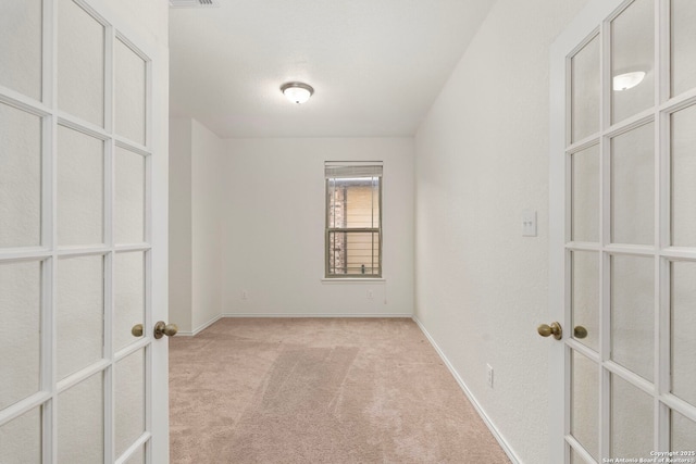 unfurnished bedroom with light colored carpet